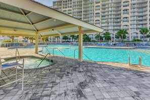 A swimming pool area with a covered deck, lounge chairs, and a hot tub. - Tee Times & Pool Vibes! North Myrtle Beach Retreat (North Myrtle Beach)