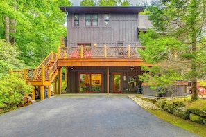 Ein zweistöckiges Holzhaus mit Balkon, Treppe und Eingangstür.