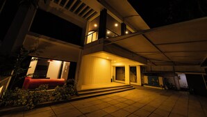 A modern two-story building with a covered entrance and a staircase leading to the upper floor. - ELIVAAS Gerrys 4BHK Villa with Terrace (Chennai)