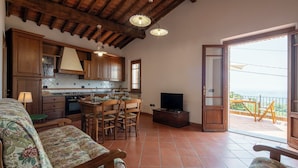 A spacious living area with a kitchen, dining set, and a balcony with a view. - Vacation Home in Lamporecchio with 1 bedrooms sleeps 4 (Lamporecchio)