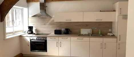 Coffee/tea maker, fridge, stovetop, dishwasher