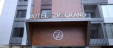 A hotel sign with the name 'HOTEL ZP GRAND' and a logo.