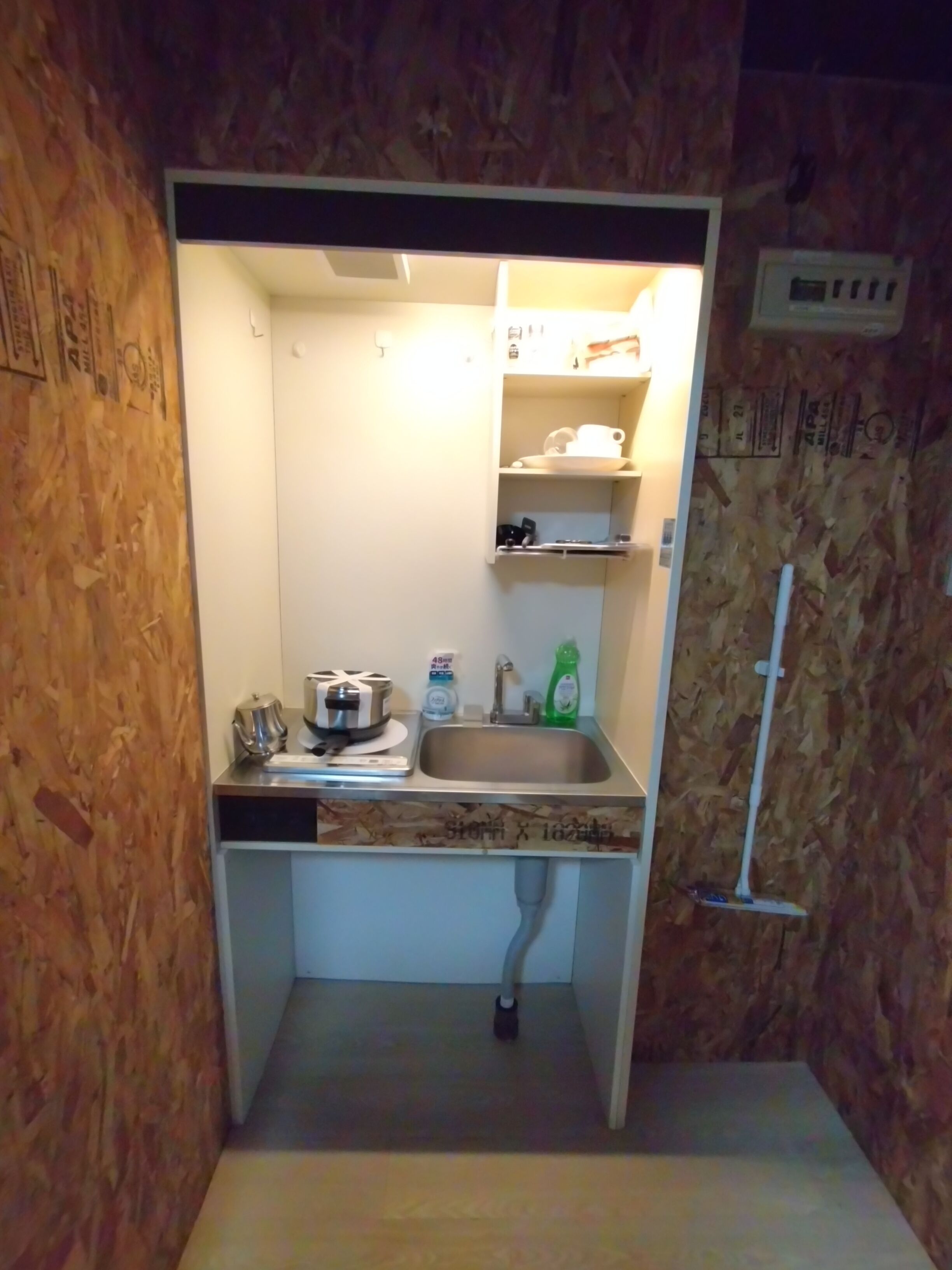 A compact kitchen with a sink, a stove, and a small countertop.