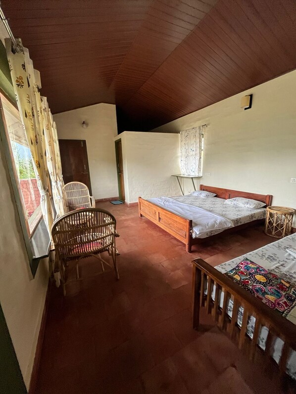 A room with a bed, a chair, and a small table.