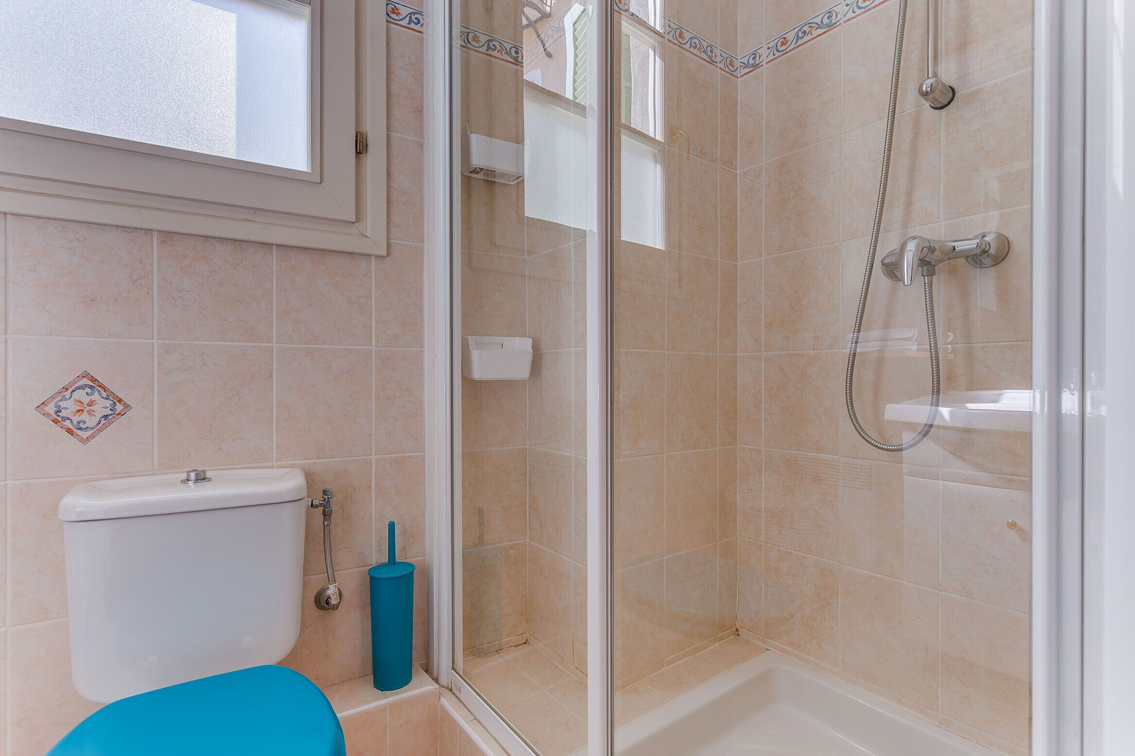 A bathroom with a toilet, a shower, and a bathtub.