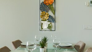 A dining area with a glass table set for four, surrounded by chairs. - CostaBlancaDreams - Arenal Beach 10 in Calpe (Calpe / Calp)