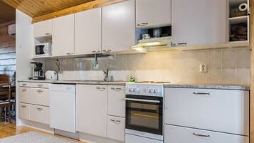 A kitchen with white cabinets, a microwave, a stove, and a dishwasher.