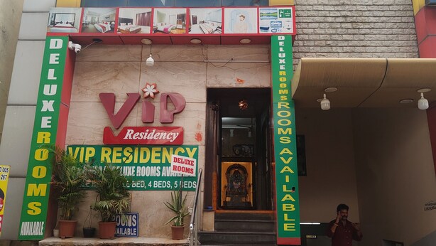 A building with a sign for 'VIP Residency Deluxe Rooms' and a staircase leading to the entrance. - VIP Residency (Tirupati)