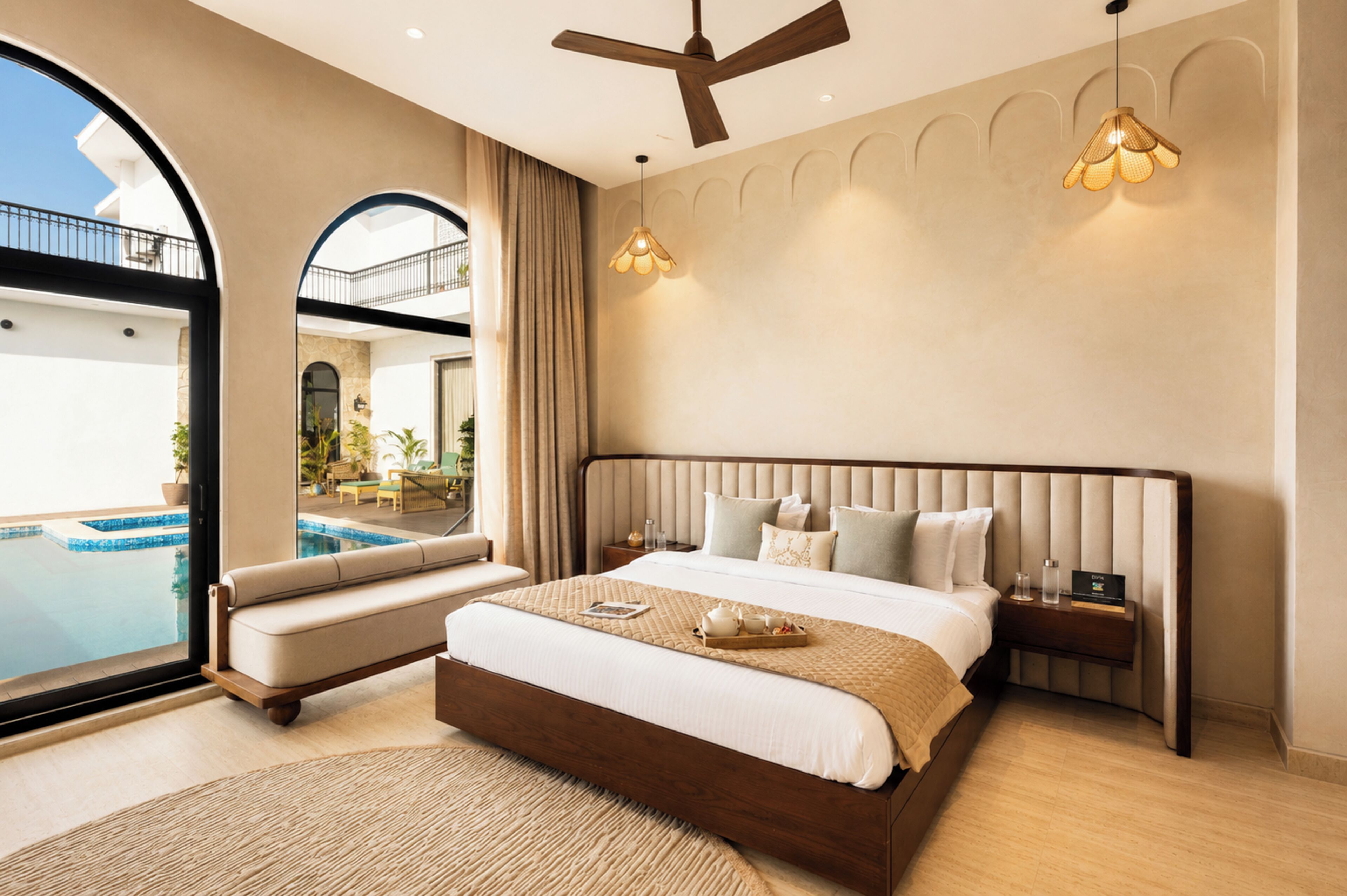 A spacious bedroom with a large bed, a view of a swimming pool, and a balcony.