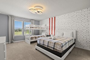 A bedroom with bunk beds, a large window, and a patterned wall. - Book Your Christmas Stay/Your Holiday Gift Awaits! (Davenport)