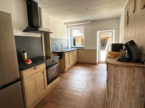 A kitchen with a stove, oven, and a coffee maker. - House built in 1927, perfect for families, in the countryside (La Bourgonce)