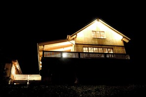 A large, two-story wooden house with a prominent front porch and a balcony. - ROMANTIKHÜTTE ROTHAARSTEIG – An idyllic chalet with panoramic views – accommodates up to 8 people (Schmallenberg)