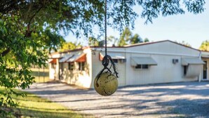 A hanging object with a rope, a building with a white facade, and a clear sky. - The big catch! - 3.5 acres - pets! - boats - fishing and crabbing! (Rodds Bay)
