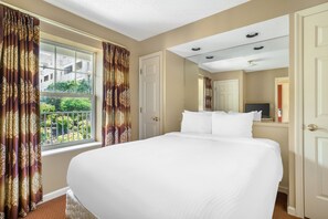 A hotel room with a large bed, a window with curtains, a door, and a ceiling with recessed lighting. - Relaxing 1BR Retreat Minutes from Dollywood (Pigeon Forge)