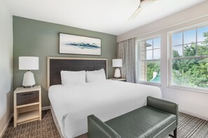 A hotel room with a bed, two bedside tables, a chair, a ceiling fan, a window with curtains, and a painting on the wall. - Dollywood Adventures Start at This Spacious 2BR Retreat (Pigeon Forge)