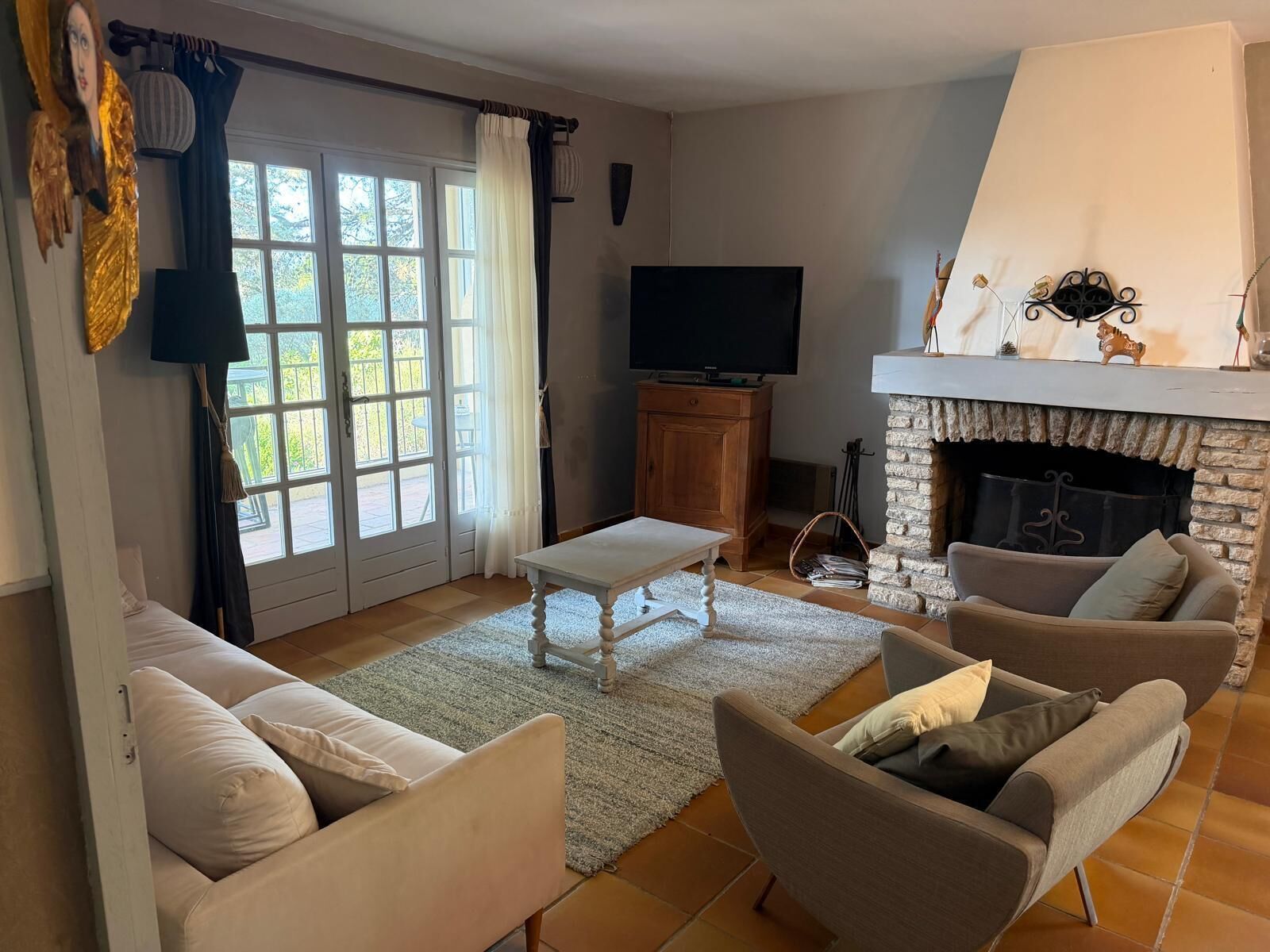 A living room with a fireplace, a television, and a sofa.