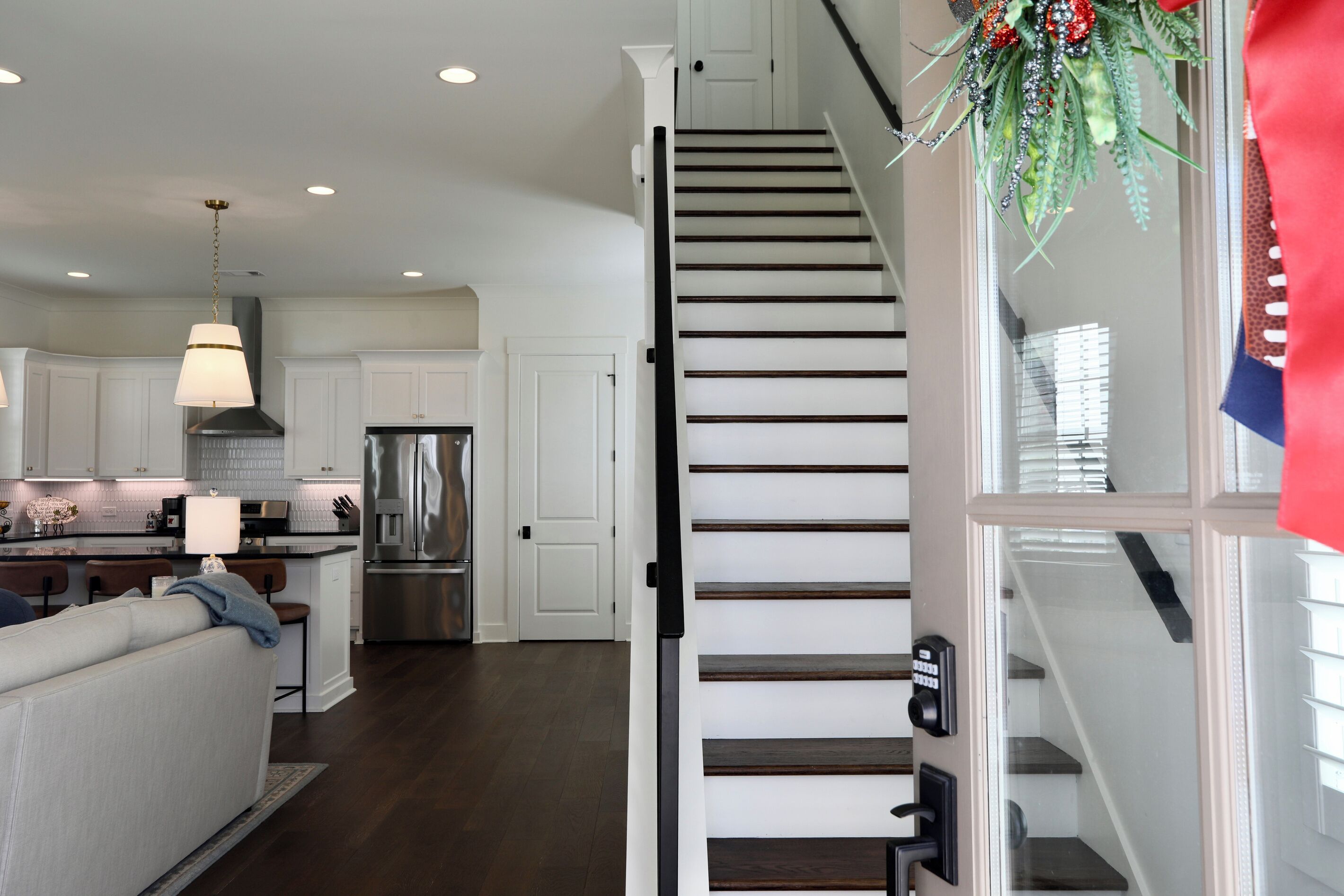 A modern kitchen with white cabinetry, stainless steel appliances, and a central island.