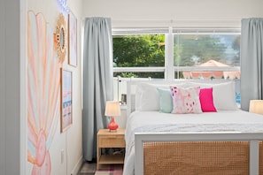 A bedroom with a bed, bedside tables, a lamp, and a window with curtains. - Family Home Retreat•Hot Tub•Heated Pool•Mini-Golf (Seminole)