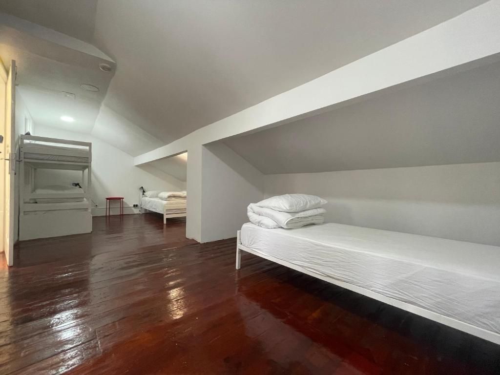 A room with a bunk bed, a small table, and a chair.