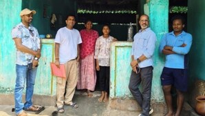 A group of people standing in front of a building with a green facade and a traditional entrance. - GaindaPhool Homestay, Chhichhli - Jashpur (Ganjenar)