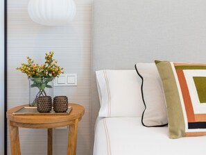 A neatly arranged room with a bed, a bedside table with decorative items, and a wall-mounted light fixture. - Luxurious villa with private pool in Antequera (Antequera)