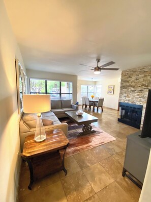A living room with a sofa, coffee table, and fireplace. - Sweeping views of the Catalina Mountain from this corner 3 bedroom (Tucson)