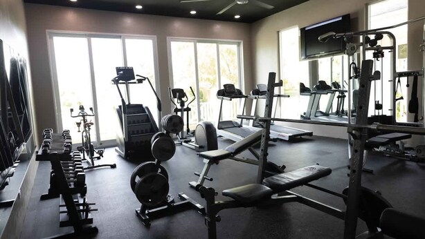 A gym with treadmills, weight machines, and dumbbells. - Silk Cotton Studio 2 (Nassau)