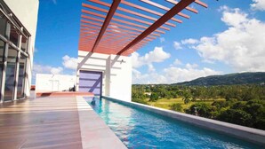 A modern outdoor swimming pool with a clear view of the surrounding landscape. - 3BR Luxury Penthouse Suite - Dream 36  (Montego Bay)