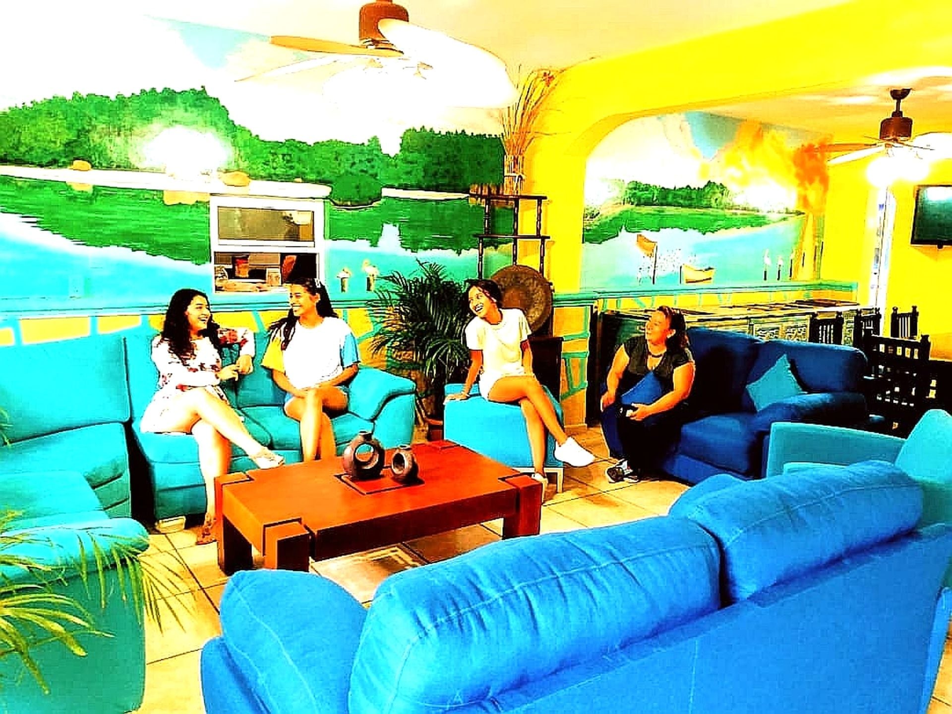 A living room with blue sofas, a coffee table, and a TV.