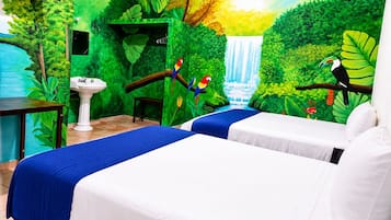 A room with two beds, a sink, and a mural of a waterfall and jungle.