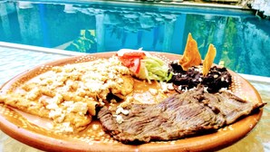 A meal with a pool in the background.