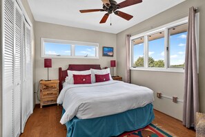 A bedroom with a bed, a ceiling fan, a window with curtains, a nightstand, and a dresser. - New Listing! Vista Bonita | Private 10 Acres | Mountain Views | Shuffleboard (Santa Fe)