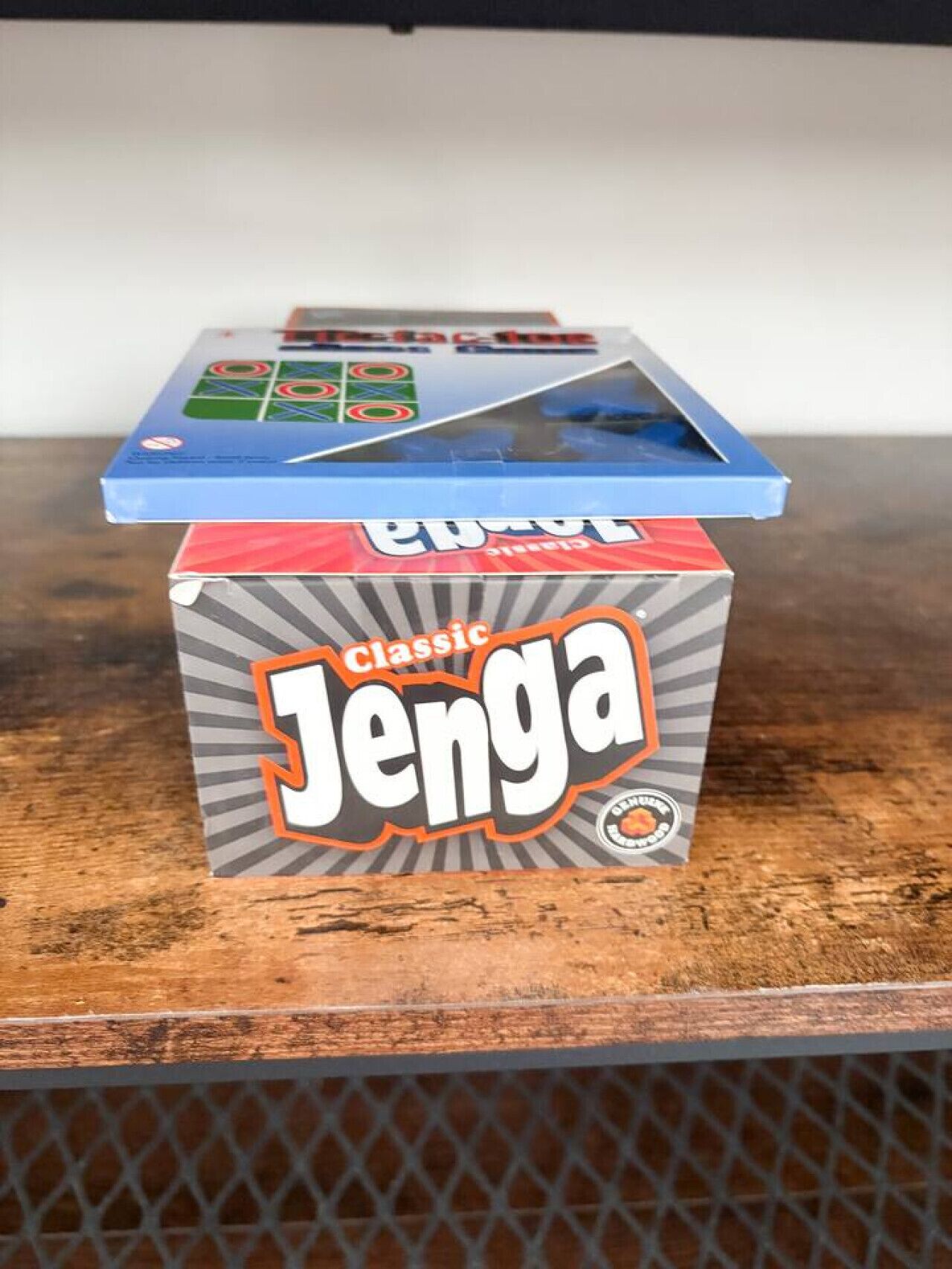 A box of Classic Jenga on a wooden surface.
