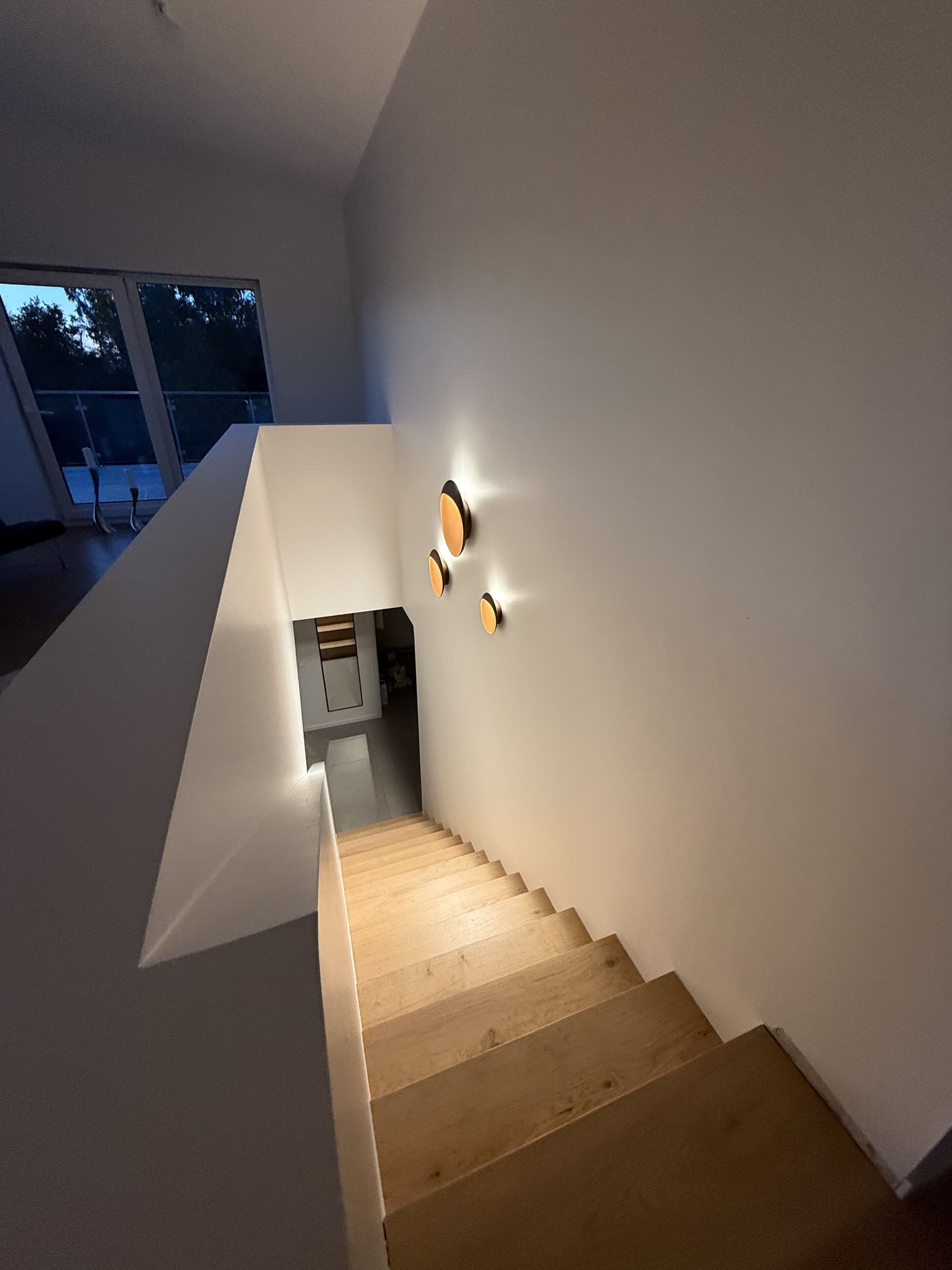 A staircase with wooden steps leading to a kitchen area.