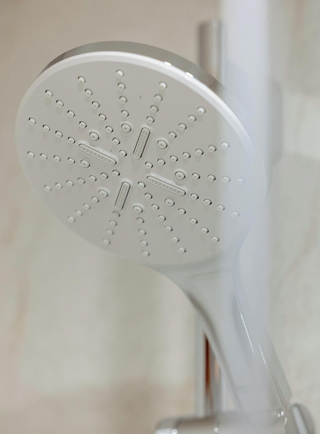 A showerhead with multiple round nozzles.