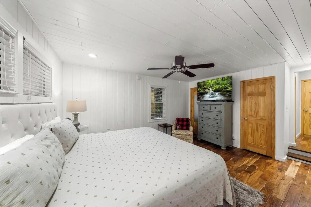 Slip into crisp linens and feel the gentle breeze from the ceiling fan as you unwind in your private retreat with warm wood floors and soft natural light.