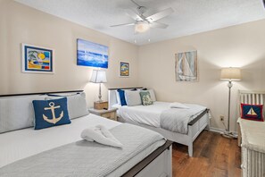A hotel room with two beds, a ceiling fan, and artwork on the walls. - 🌴Edgewater #1400 | BeachFront 2BR condo | Pool 🏖️ (Miramar Beach)