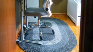 A compact room with a desk, chair, and a bed.