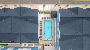 Una piscina rodeada por edificios con un diseño de techo uniforme.
