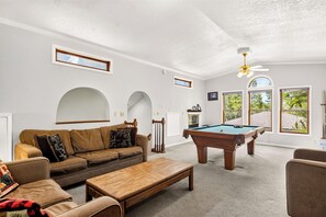 A living room with a pool table, a sofa, a coffee table, and a fireplace. - Gold King House: Hot Tub, Pool Table. Near Peak 10 (Breckenridge)