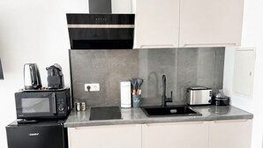 A modern kitchen with a built-in microwave, toaster, and coffee maker.