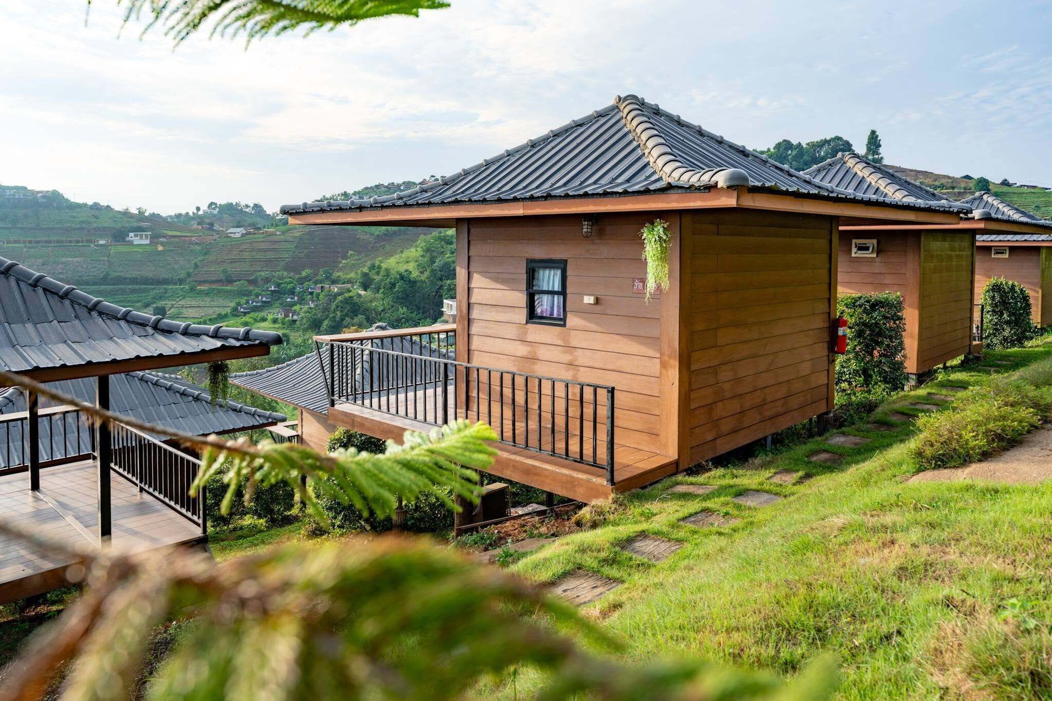 A traditional wooden building with a tiled roof, a small window, and a balcony with a railing.