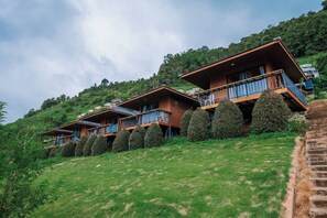A hillside property with multiple wooden buildings featuring balconies.