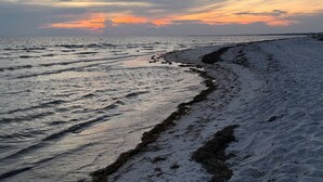 A beach with a view of the ocean and a sunset. - Beach Haven | Brand New Home | WindMark (Port St. Joe)