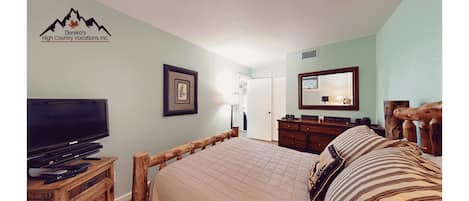 Your mountain retreat awaits with a rustic log bed, cozy linens, and warm wood furnishings. Unwind with your favorite shows or drift off to peaceful alpine dreams.