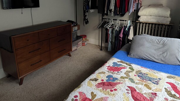 A bedroom with a bed, dresser, closet, and a television on the wall. - Little League Getaway - Sleeps 10 - Spacious 4-bedroom, mins from stadium (Williamsport)