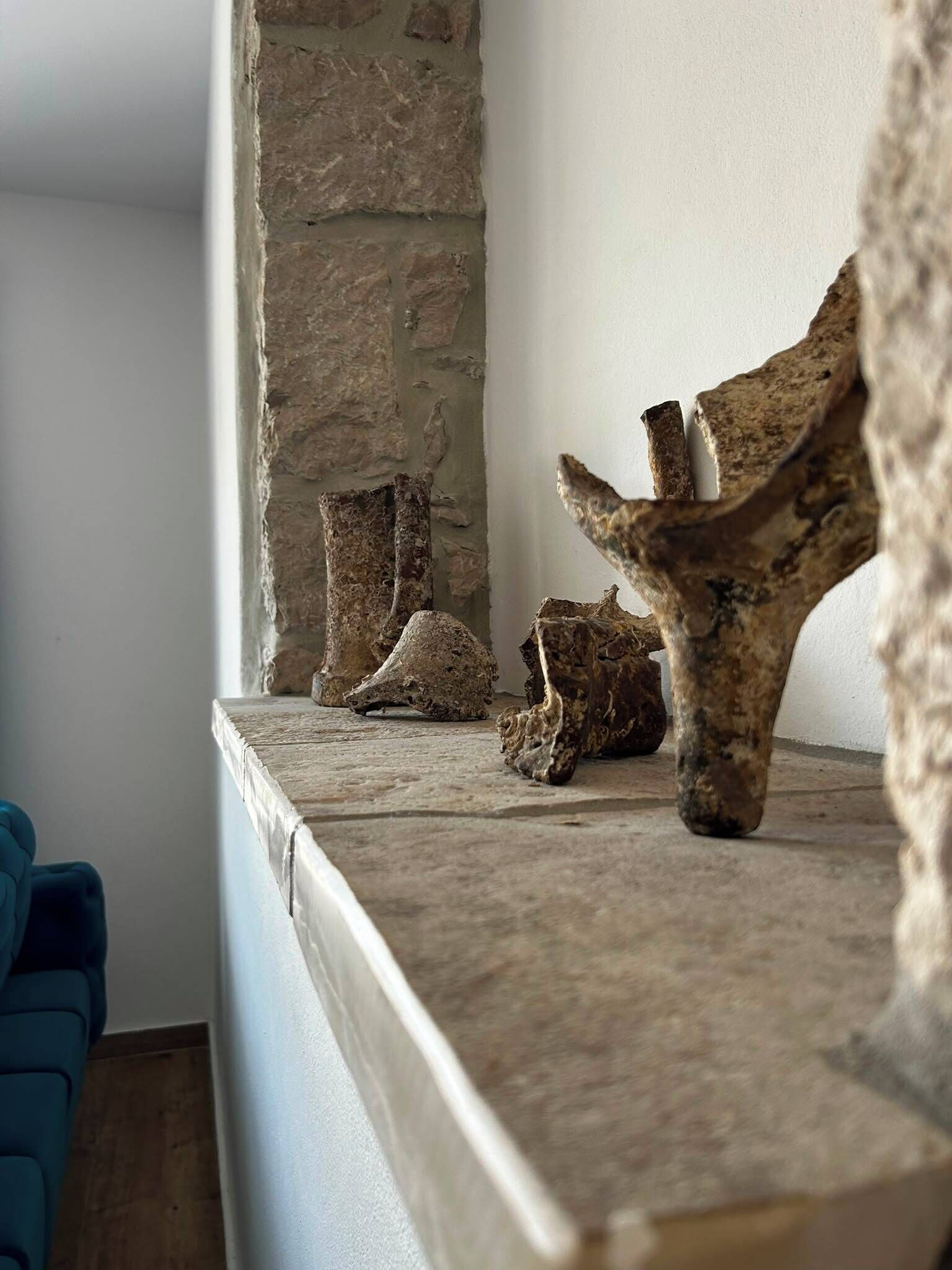 A stone fireplace with rustic decor.