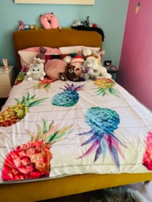 A bed with a pineapple-themed quilt, a pink stuffed toy, and a variety of other plush toys. -  A  traditional, tropical Mauritian villa, 3-4 mins walk  to an amazing beach. (Balaclava)