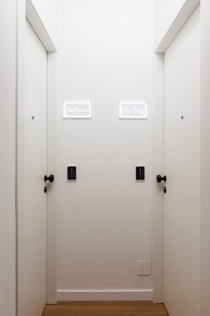 A white door with two illuminated signs reading 'The Harbor' and 'The Sang' above a keypad lock. - The Harbour - Boutique sea view room in Dubrovnik (Dubrovnik)