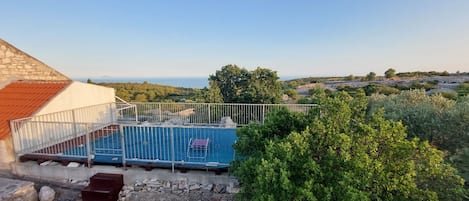 A rooftop pool with a view of the surrounding landscape.